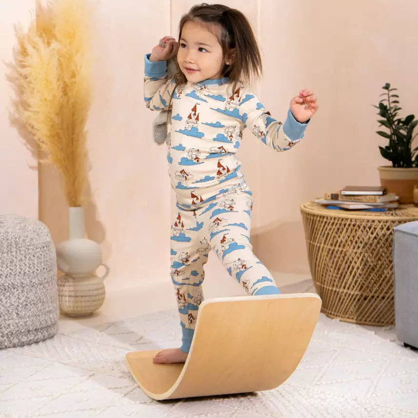 Child in pajamas playing on Balance Board