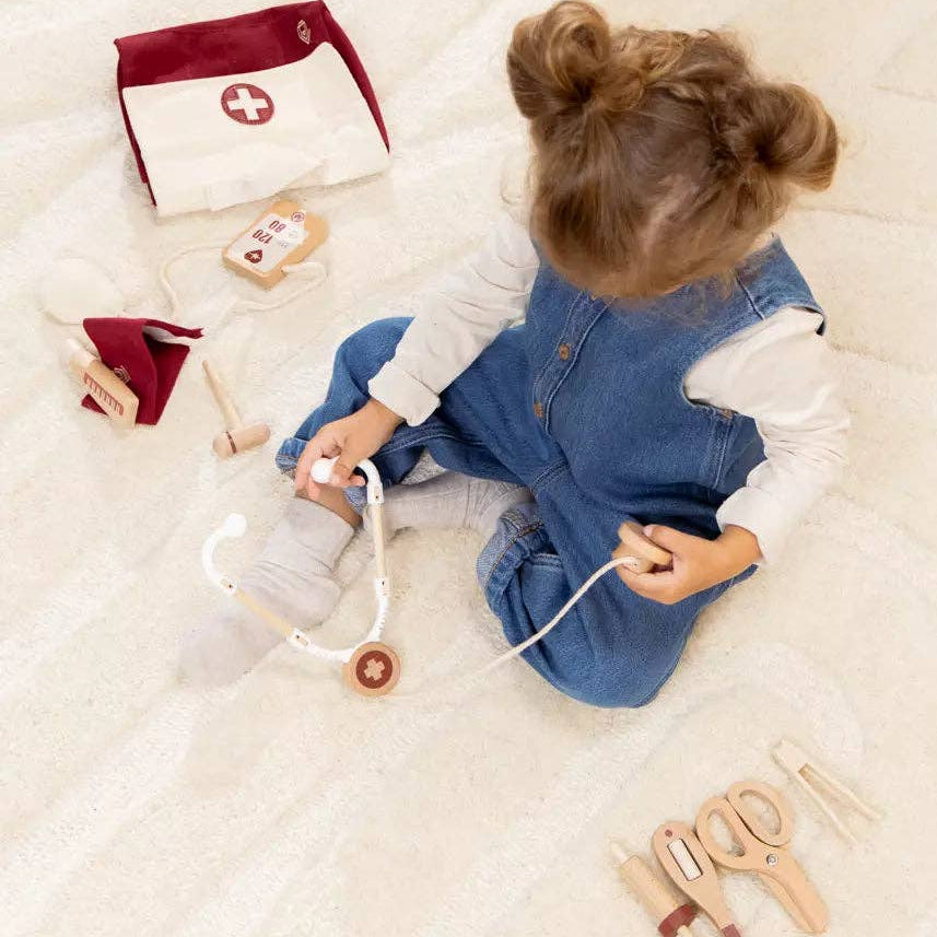 Child playing with doctor playset