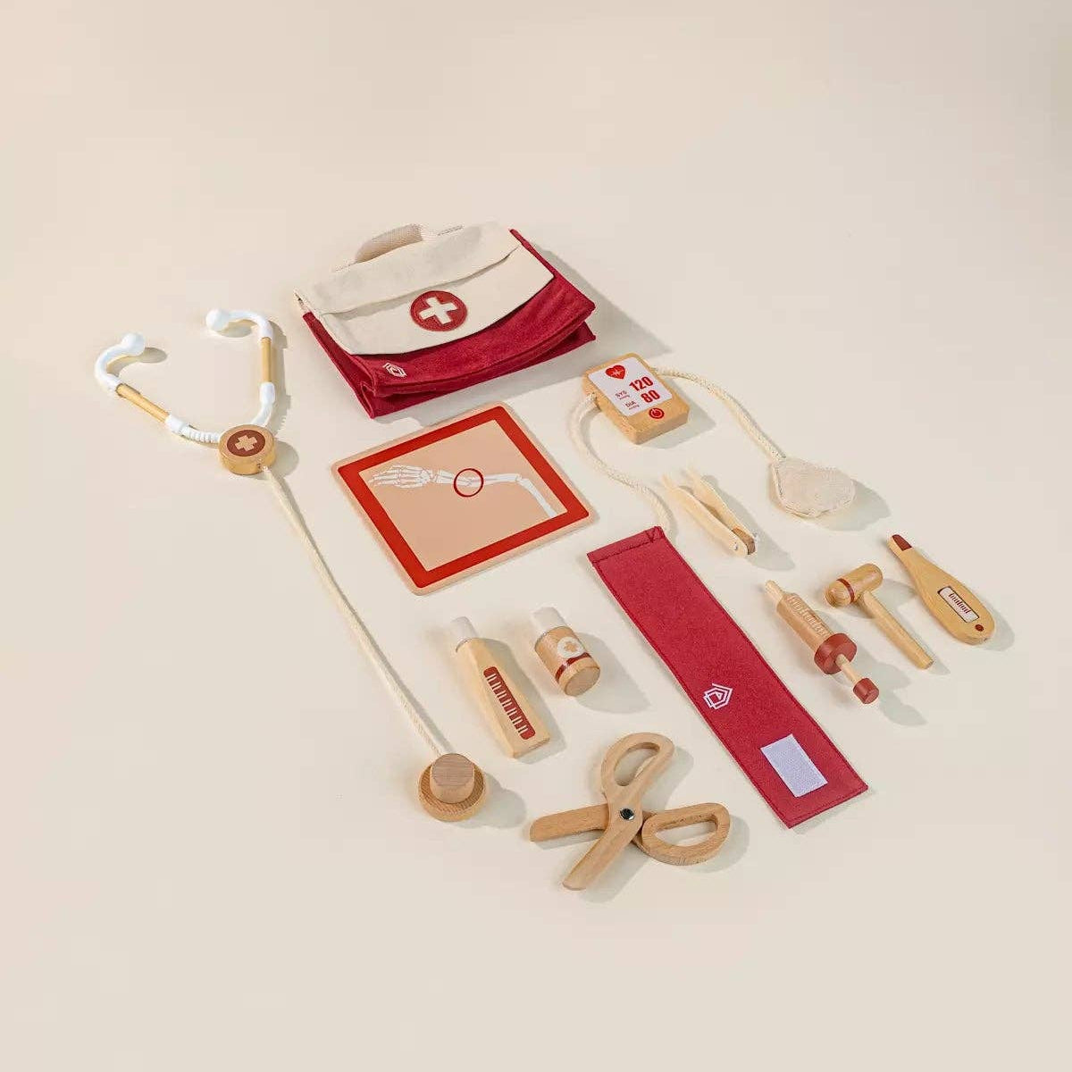 Wooden toy medical set with stethoscope, syringe, and other tools.