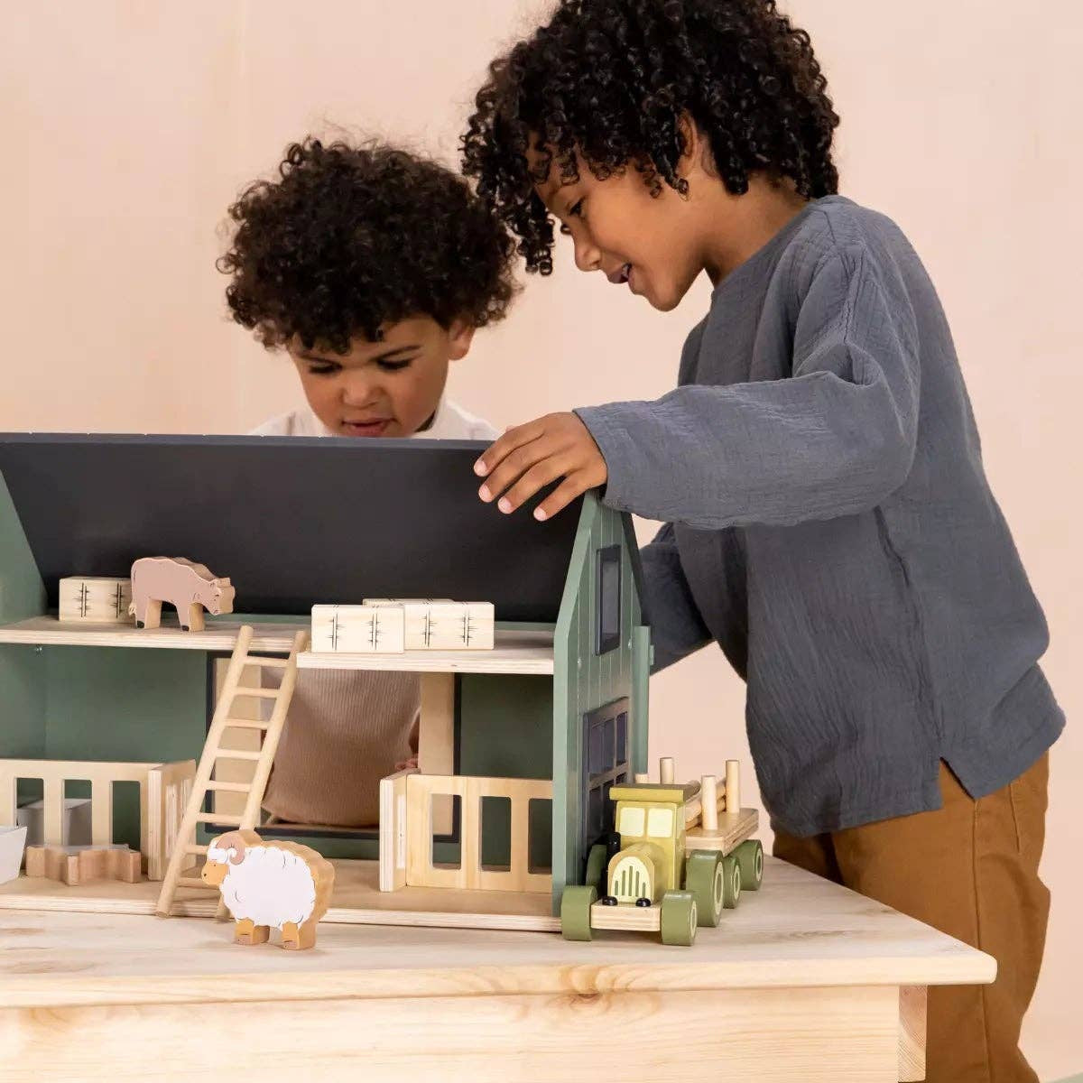 Two children playing with wooden toys on a table.