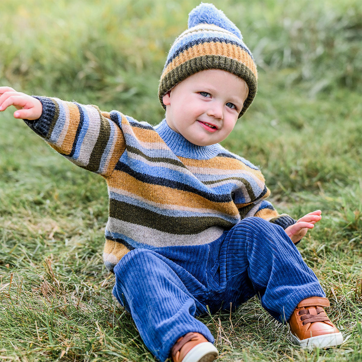 sweater and hat with dusty blue cords sitting