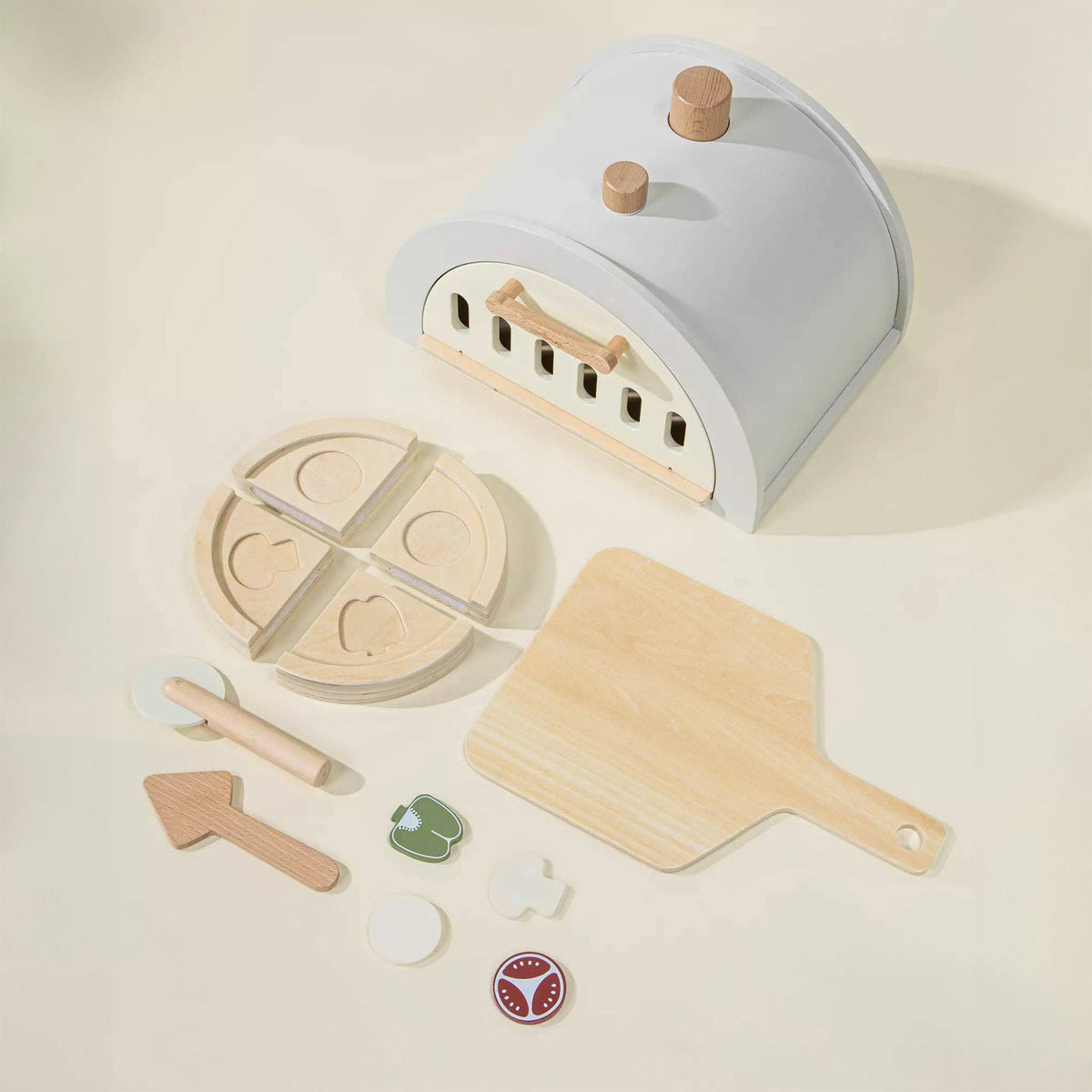 Toy pizza oven with wooden pizza, spatula, and toppings 